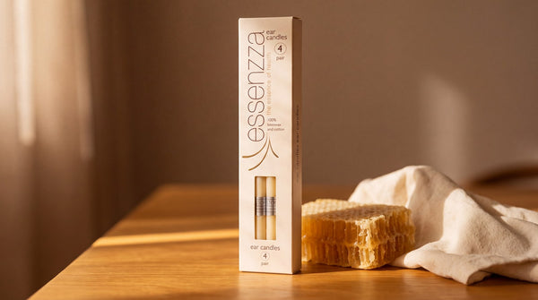 Essenzza Original ear candles standing beside natural honeycomb and unbleached cotton.