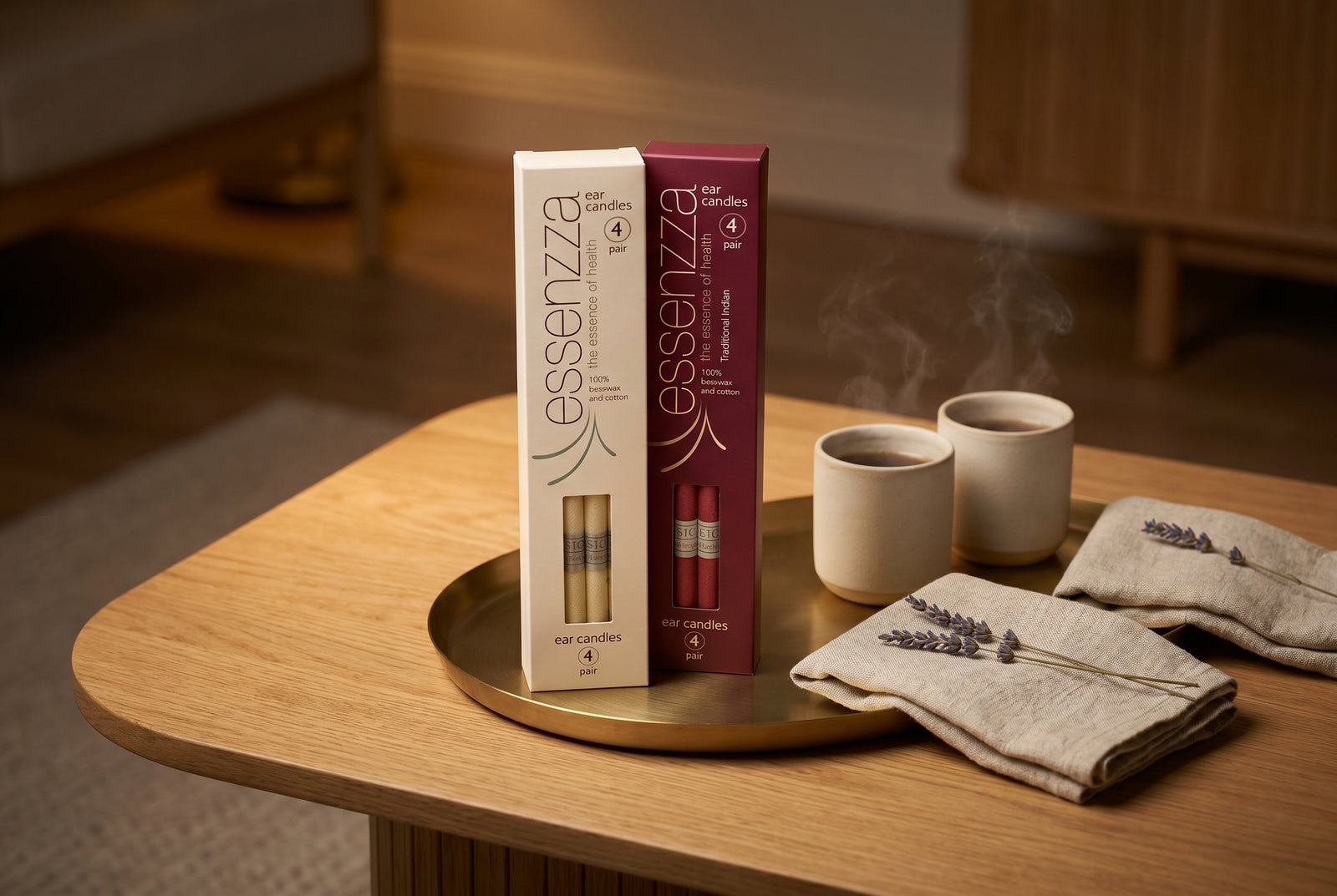 Essenzza beeswax and traditional Indian ear candles in their branded packaging, set on a tray in a warm, calm room